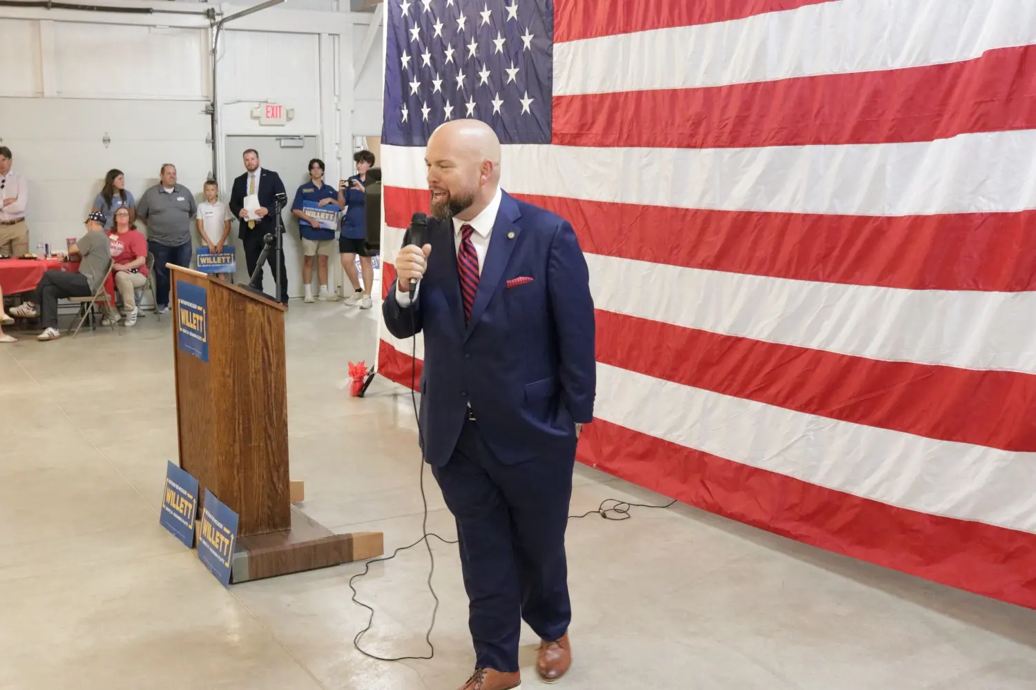 Chris Stigall speaking with a microphone at the Willett kickoff podium
